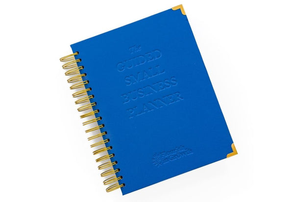 Front photo of The Guided Small Business Planner. This bright blue cover has the words, "The Guided Small Business Planner" embossed on the front with the Flourish In Growth logo underneath
