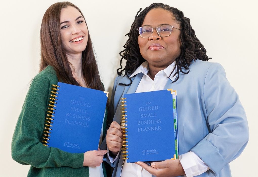 Small business owners holding a copy of the Guided Small Business Planner