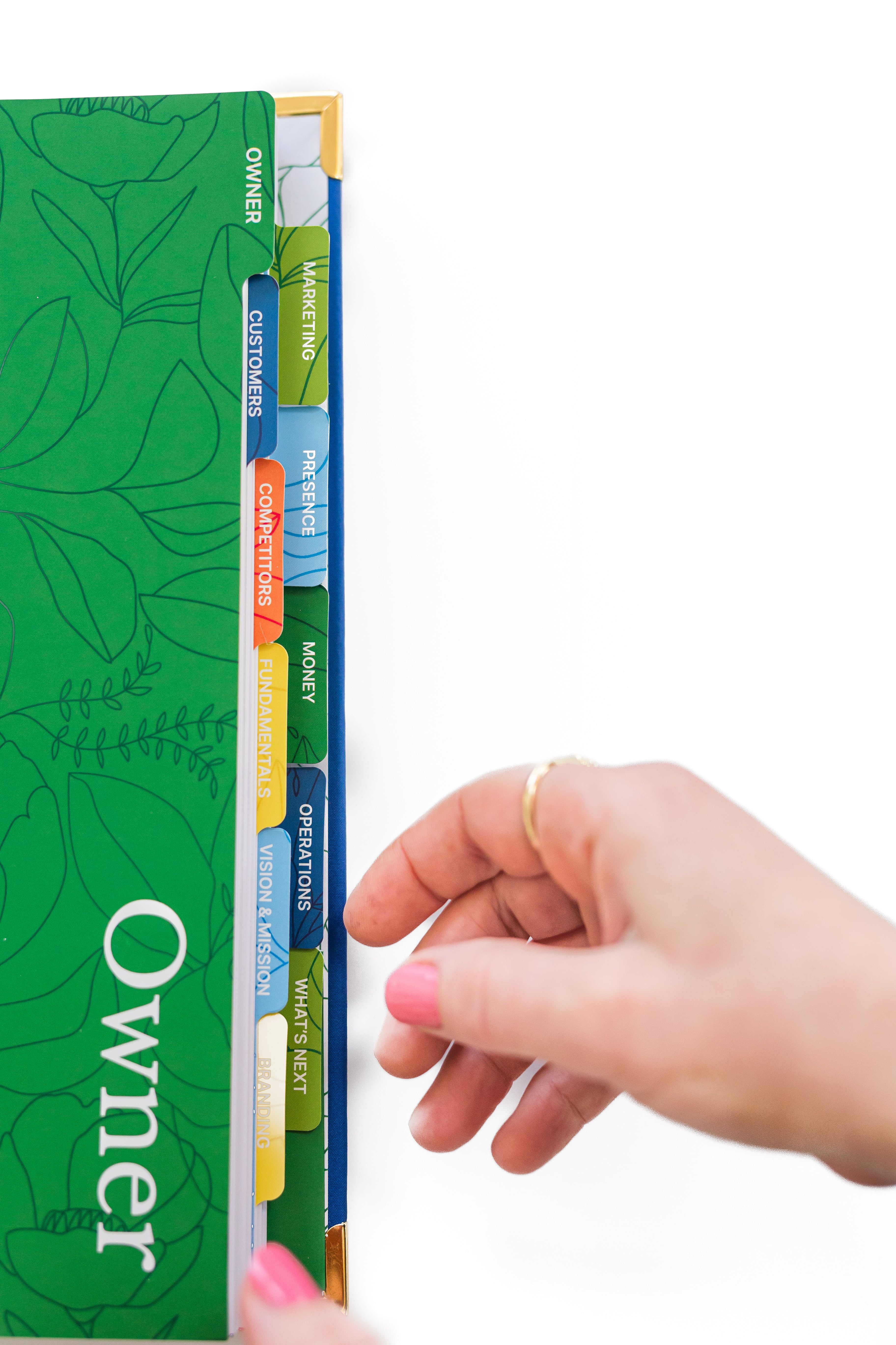 Image of the tabs of each section of The Guided Small Business Planner. Brightly colored tabs for all 11 sections.