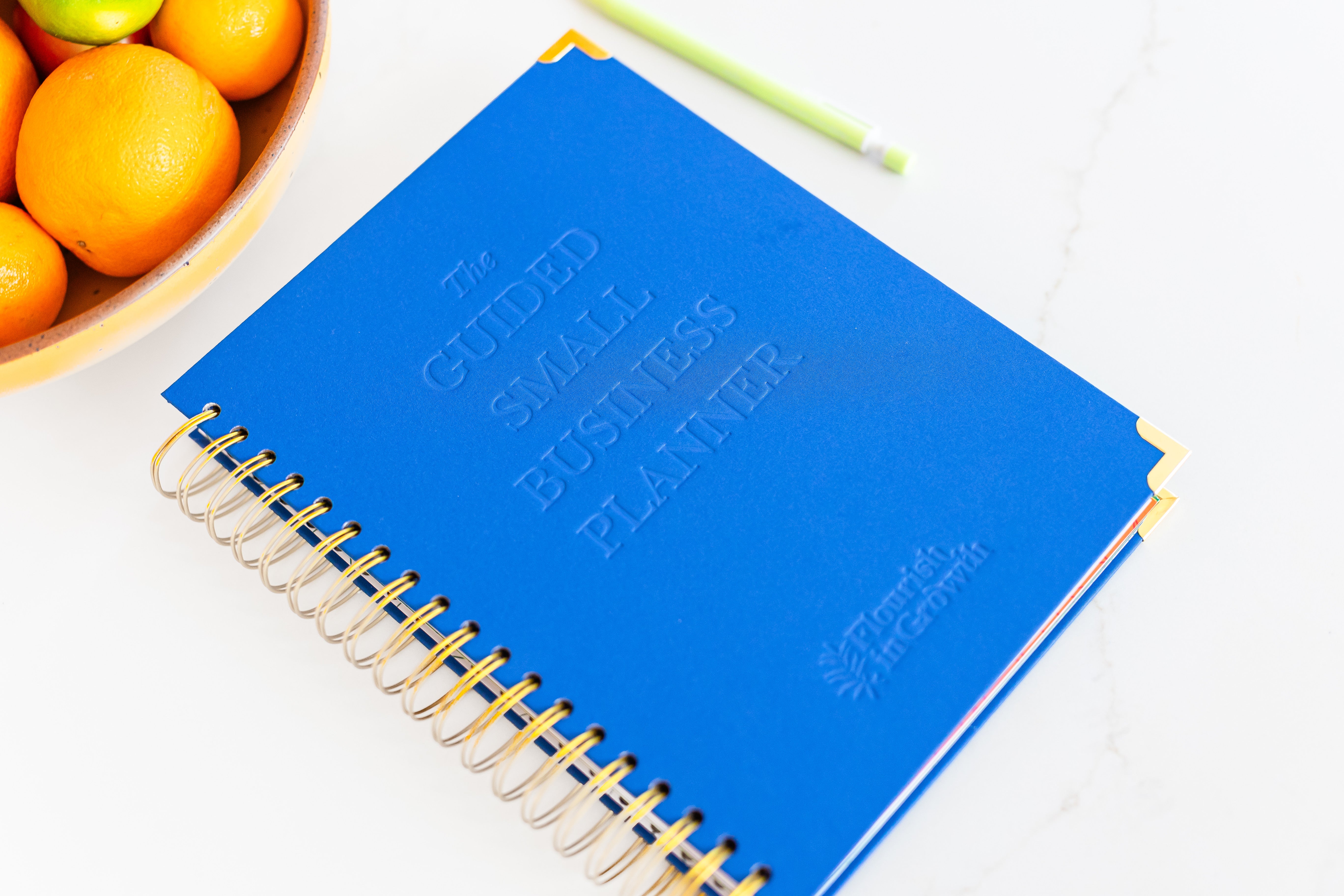 Hero image of The Guided Small Business Planner - laying flat with the cover shown.